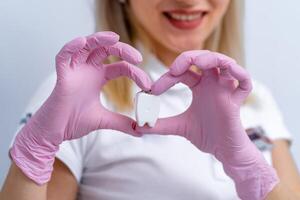 Female doctor and patient showing heart shape. Doctor's hand closeup. Medical help, prophylaxis or insurance concept. Health, protection and prevention. photo