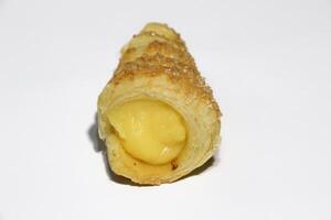 Cream puffs filled vanilla custard and dusted with icing on a rack photo