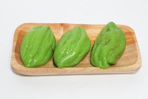 Kue Bugis, Indonesian jajan pasar, traditional snack of glutinous rice flour cake filled with sweet grated coconut, underlined with banana leaf. Popular snack during Ramadan as Takjil photo