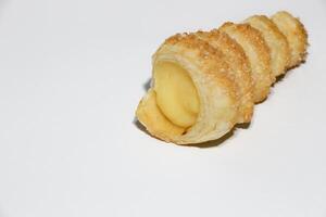 Cream puffs filled vanilla custard and dusted with icing on a rack photo