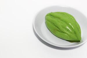 Kue Bugis, Indonesian jajan pasar, traditional snack of glutinous rice flour cake filled with sweet grated coconut, underlined with banana leaf. Popular snack during Ramadan as Takjil photo