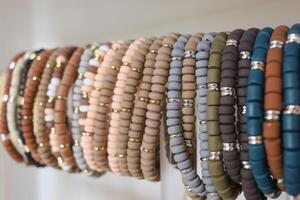 Clay and gold and silver bracelets on a display. photo