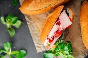 sandwich ham, tomato, green lettuce healthy eating cooking appetizer meal food snack on the table copy space food background rustic top view photo