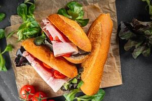 sandwich ham, tomato, green lettuce healthy eating cooking appetizer meal food snack on the table copy space food background rustic top view photo