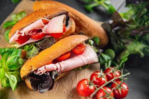 sandwich ham, tomato, green lettuce healthy eating cooking appetizer meal food snack on the table copy space food background rustic top view photo