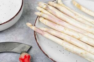 Raw white asparagus, spring season. photo