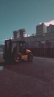 Forklift Driving Down Street Next to Factory video