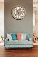 a living room with a couch and a clock photo