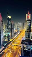 a cityscape at night with traffic lights and buildings photo