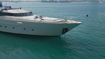 Dubai, UAE - 3 20 2023. A drone flies around a luxury private yacht standing in a calm sea video