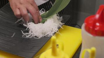 Making sushi with daikon, leaves and fish video