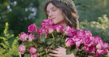 Girl with a wreath of flowers holds a bouquet video
