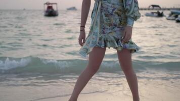 The feet of a young woman walking the sandy shore video