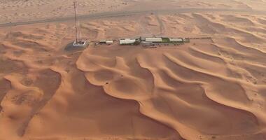 A drone flies over the roof of a sports complex in the desert sands of the UAE video