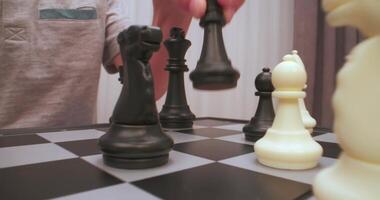 Boy plays chess. Chess figures extreme closeup. video