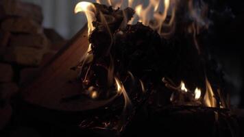 An open book burning in a fire of dry vets at night in an ancient building in oriental style video