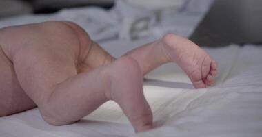 New born naked baby boy lies on the stomach video