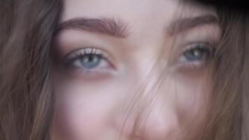 Face young woman with gray eyes and long flowing hair video