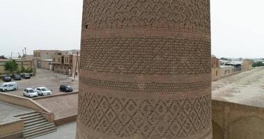 A drone flies around the famous memorial complex Kalyan Poi Kalon Complex and Poi Kalon Minaret, Poi Kalan or Po-i-Kalyan in Bukhara at dawn video