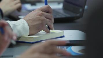 Hands of an businessman in expensive clothes work at computers in the office. video