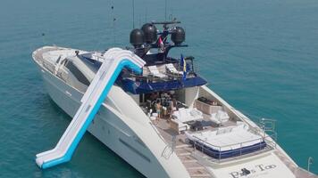 Dubai, UAE - 3 20 2023. A drone flies around a luxury private yacht standing at sea against the backdrop of Dubai's skyscrapers video