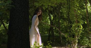 Young girl runs through a summer flowering garden video