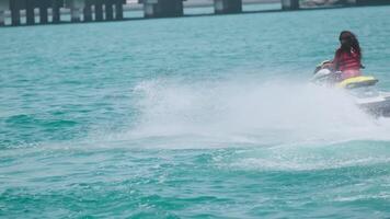 Young swarthy woman in life jacket on jet ski on the high seas video