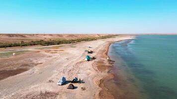 Drone flies over fishermen on the shore of the lake video