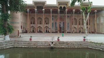 And old eastern building with high wooden carved columns on the pediment placed near the artificial pond video