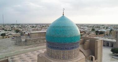 A drone flies around the Mir I Arab Madressa famous memorial complex in Bukhara at dawn video