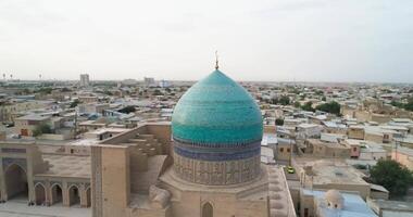 A drone flies around the Mir I Arab Madressa famous memorial complex in Bukhara at dawn video