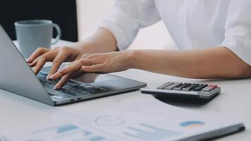 Business woman using calculator for do math finance on wooden desk in office and business working background, tax, accounting, statistics and analytic research concept video