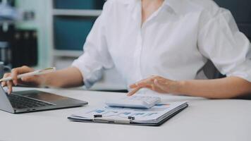 Business woman using calculator for do math finance on wooden desk in office and business working background, tax, accounting, statistics and analytic research concept video