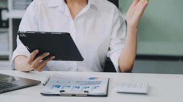 Business woman using calculator for do math finance on wooden desk in office and business working background, tax, accounting, statistics and analytic research concept video