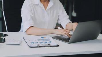 Business woman using calculator for do math finance on wooden desk in office and business working background, tax, accounting, statistics and analytic research concept video