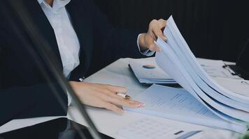 Business woman using calculator for do math finance on wooden desk in office and business working background, tax, accounting, statistics and analytic research concept video