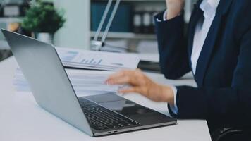 Business woman using calculator for do math finance on wooden desk in office and business working background, tax, accounting, statistics and analytic research concept video