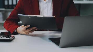 Business woman using calculator for do math finance on wooden desk in office and business working background, tax, accounting, statistics and analytic research concept video