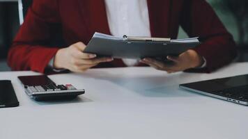 Business woman using calculator for do math finance on wooden desk in office and business working background, tax, accounting, statistics and analytic research concept video