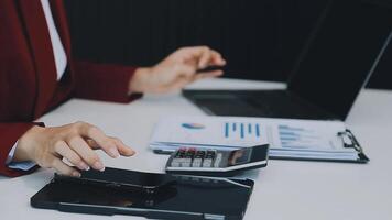 Business woman using calculator for do math finance on wooden desk in office and business working background, tax, accounting, statistics and analytic research concept video
