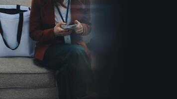 Silhouette of cropped shot of a young man working from home using smart phone and notebook computer, man's hands using smart phone in interior, man at his workplace using technology, flare light video