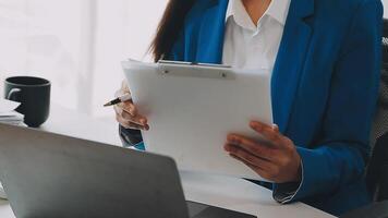 Business woman using calculator for do math finance on wooden desk in office and business working background, tax, accounting, statistics and analytic research concept video