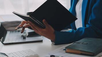 Business woman using calculator for do math finance on wooden desk in office and business working background, tax, accounting, statistics and analytic research concept video