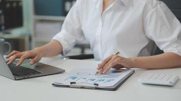 Business woman using calculator for do math finance on wooden desk in office and business working background, tax, accounting, statistics and analytic research concept video