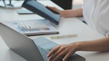 Business woman using calculator for do math finance on wooden desk in office and business working background, tax, accounting, statistics and analytic research concept video