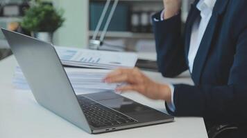 Business woman using calculator for do math finance on wooden desk in office and business working background, tax, accounting, statistics and analytic research concept video