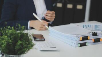 Business woman using calculator for do math finance on wooden desk in office and business working background, tax, accounting, statistics and analytic research concept video