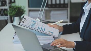 Business woman using calculator for do math finance on wooden desk in office and business working background, tax, accounting, statistics and analytic research concept video