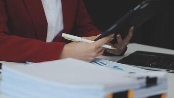 Business woman using calculator for do math finance on wooden desk in office and business working background, tax, accounting, statistics and analytic research concept video