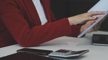 Business woman using calculator for do math finance on wooden desk in office and business working background, tax, accounting, statistics and analytic research concept video